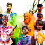 family in colorful powder celebrating holi