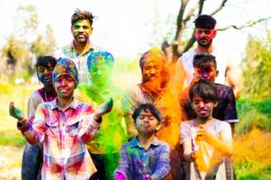 family in colorful powder celebrating holi