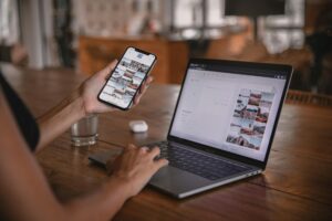 woman using smartphone and laptop