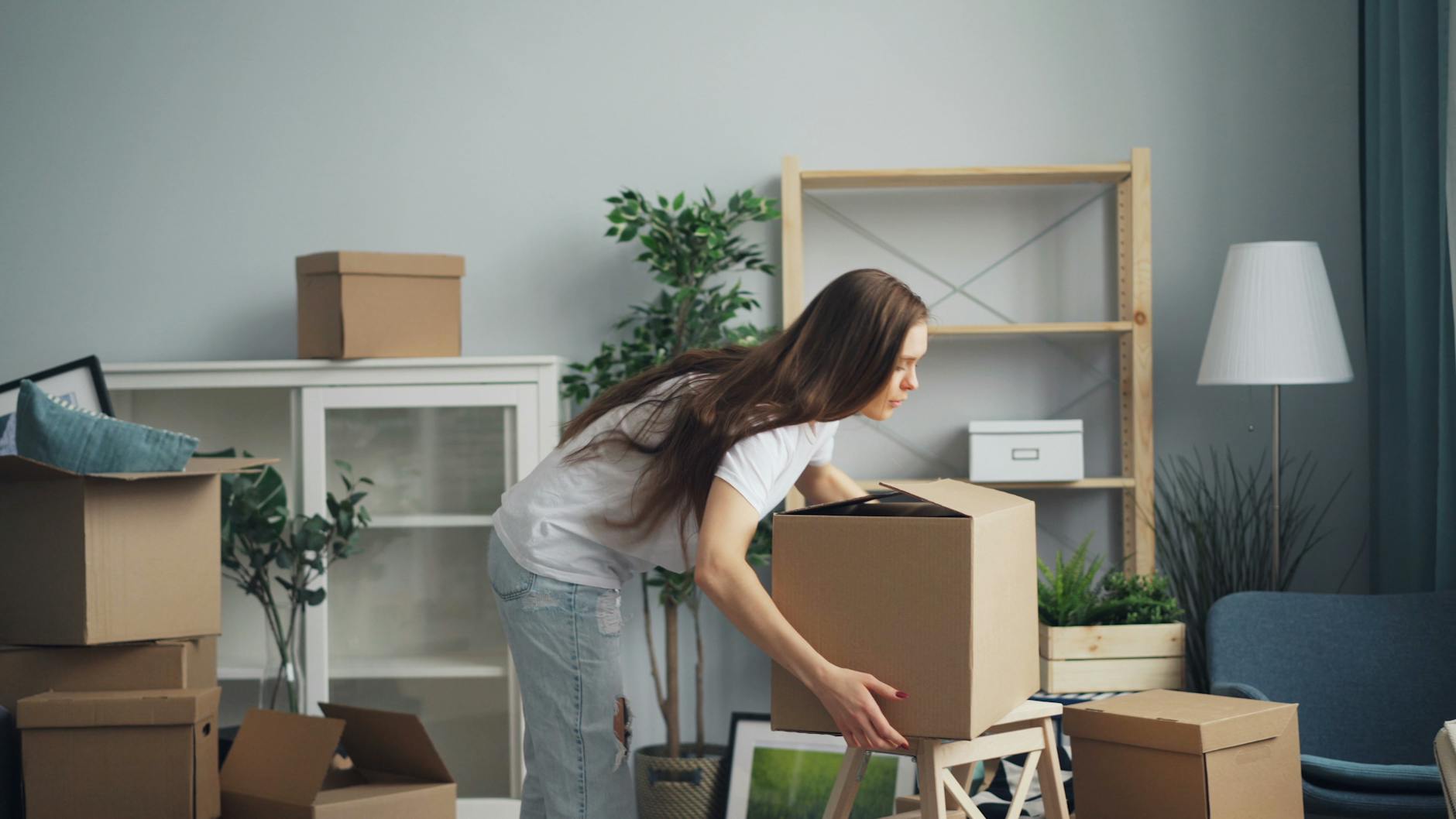 woman with boxes in house