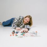 bearded man lying on the floor holding gaming chips