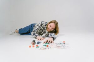 bearded man lying on the floor holding gaming chips